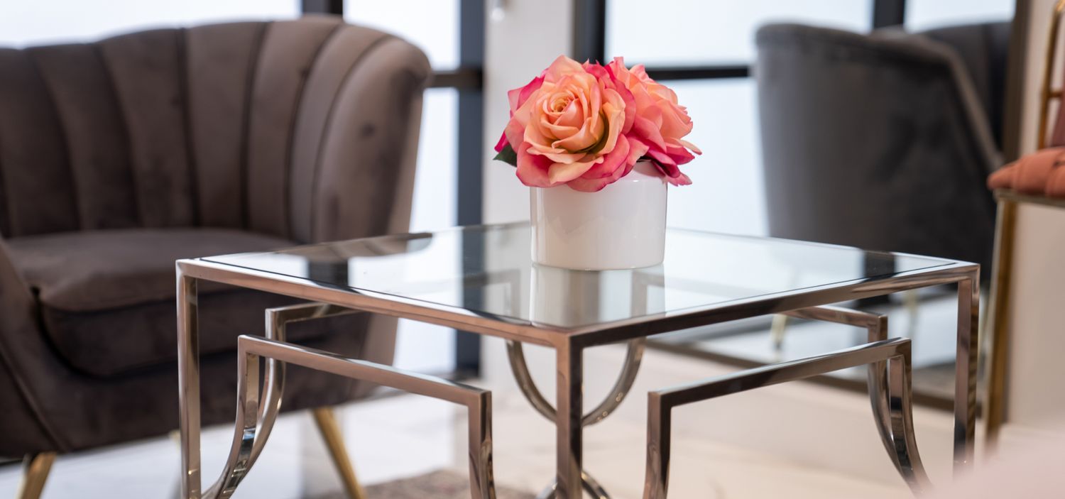 Modern living room with flowers and stylish furniture.