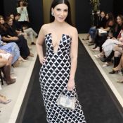 Model in stylish black and white patterned dress.